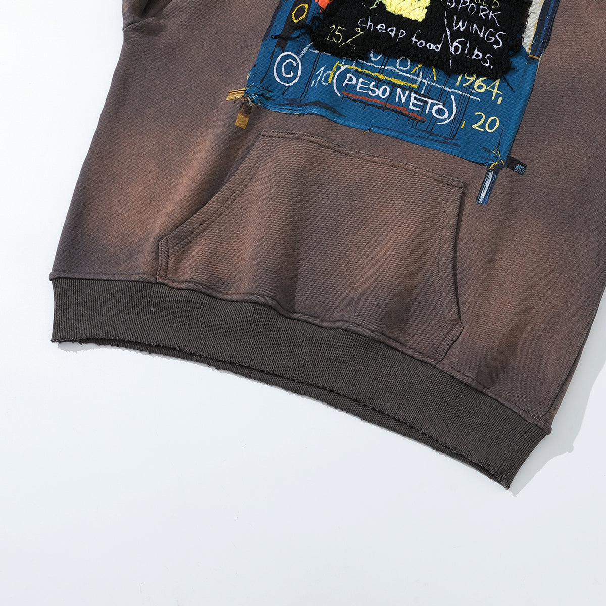 Arkyve X Basquiat Peso Neto Hoodie, hem and pocket detail